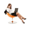 Businesswoman in chair with laptop and phone Royalty Free Stock Photo