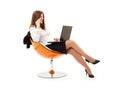 Businesswoman in chair with laptop and phone Royalty Free Stock Photo