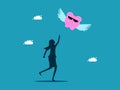 Businesswoman chasing a piggy bank that flies away from him. Saving money and losing benefits. Royalty Free Stock Photo