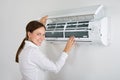 Businesswoman Checking Air Conditioner Royalty Free Stock Photo