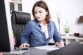 Businesswoman checking figures on a calculator