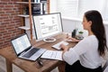 Businesswoman Checking Invoice On Computer Royalty Free Stock Photo