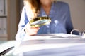 Businesswoman Checking Invoice With Magnifying Glass Royalty Free Stock Photo