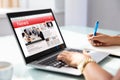 Businesswoman Checking Online News On Laptop Royalty Free Stock Photo