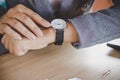 Businesswoman checking the time on watch at her office waiting for someone Royalty Free Stock Photo