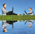 Businesswoman and child sit with notebooks Royalty Free Stock Photo