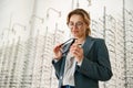 Businesswoman chooses a spectacle frame in an optician's shop