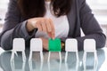 Businesswoman Choosing Green Chair Among White Chairs In A Row