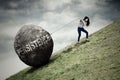 Businesswoman is climbing with a big stone Royalty Free Stock Photo