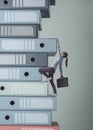 Businesswoman climbing a pile of ring binders