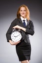 Businesswoman with clock being late