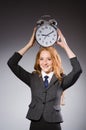 Businesswoman with clock being late