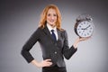 Businesswoman with clock being late