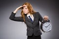 Businesswoman with clock being late