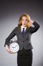 Businesswoman with clock being late