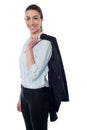 Businesswoman with coat slung over her shoulder