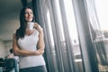 Businesswoman with coffee or tea cup looking away. Smiling and holding tea cup break after meeting