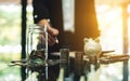 Businesswoman with coins stack , a glass money jar and piggy bank on the table for saving concept Royalty Free Stock Photo