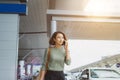 Businesswoman on commute transit talking on the smartphone while walking with hand luggage in train station or airpot going to