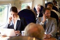 Businesswoman Commuting To Work On Train And Using Laptop