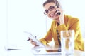 Businesswoman concentrating on work, using computer and cellphone in office Royalty Free Stock Photo