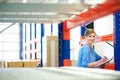 Businesswoman controlling inventory in a warehouse