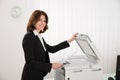 Businesswoman Copying Paper On Photocopy Machine Royalty Free Stock Photo