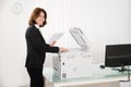 Businesswoman Copying Paper On Photocopy Machine Royalty Free Stock Photo