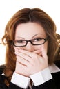 Businesswoman covering her mouth because of shame Royalty Free Stock Photo