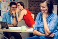 Businesswoman in deep thought and colleagues whispering in background Royalty Free Stock Photo