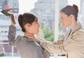 Businesswoman defending herself from her co worker strangling her Royalty Free Stock Photo