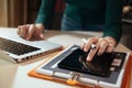 Businesswoman or Designer using tablet with laptop and document on desk in modern office. Royalty Free Stock Photo