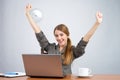 Businesswoman at desk with arms thrown up Royalty Free Stock Photo