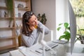 Businesswoman at the desk indoors in office, feeling pain in neck. Royalty Free Stock Photo