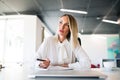 Businesswoman at the desk with laptop in her office. Royalty Free Stock Photo