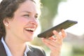 Businesswoman dictating message on phone