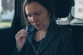 Businesswoman dictating into smartphone earphones microphone Royalty Free Stock Photo