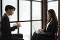 Business woman with disability using laptop computer and analyzing statistical graph with colleague. Royalty Free Stock Photo