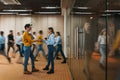 Businesswoman discussing on background of crowd office employees at coworking center