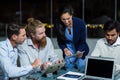 Businesswoman discussing with colleagues over digital tablet Royalty Free Stock Photo