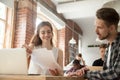 Businesswoman discussing documents at meeting with client in co-