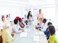 A Businesswoman Discussing in Front of her Colleagues Royalty Free Stock Photo