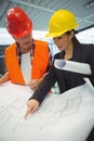 Businesswoman discussing over blueprint with a architect Royalty Free Stock Photo