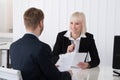 Businesswoman Discussing Over Resume With Male Candidate Royalty Free Stock Photo