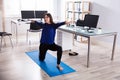 Businesswoman Doing Workout In Office