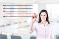 Businesswoman drawing arrows in different directions. Office background. Royalty Free Stock Photo