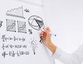 Businesswoman drawing plan on flip board Royalty Free Stock Photo