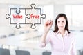 Businesswoman drawing a Value Price puzzle concept on the virtual screen. Office background.