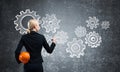 Businesswoman draws gears mechanism on blackboard Royalty Free Stock Photo