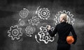 Businesswoman draws gears mechanism on blackboard Royalty Free Stock Photo